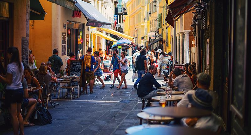 Street lined with shops and cafes in Nice, France.